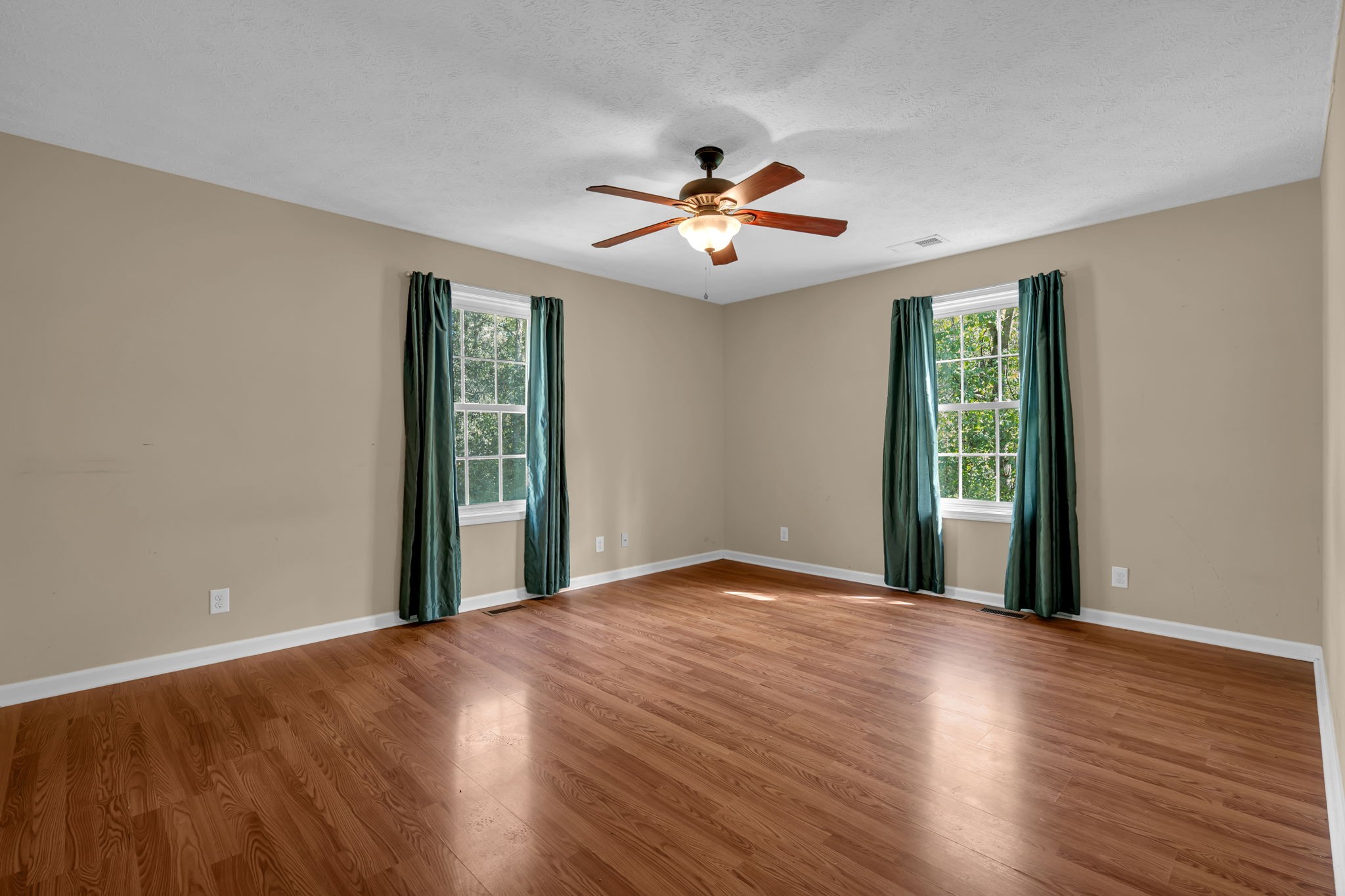 1297 Dry Creek Road Ashland City, TN 37015 - Photo 18 of 27 a view of empty room with wooden floor and fan