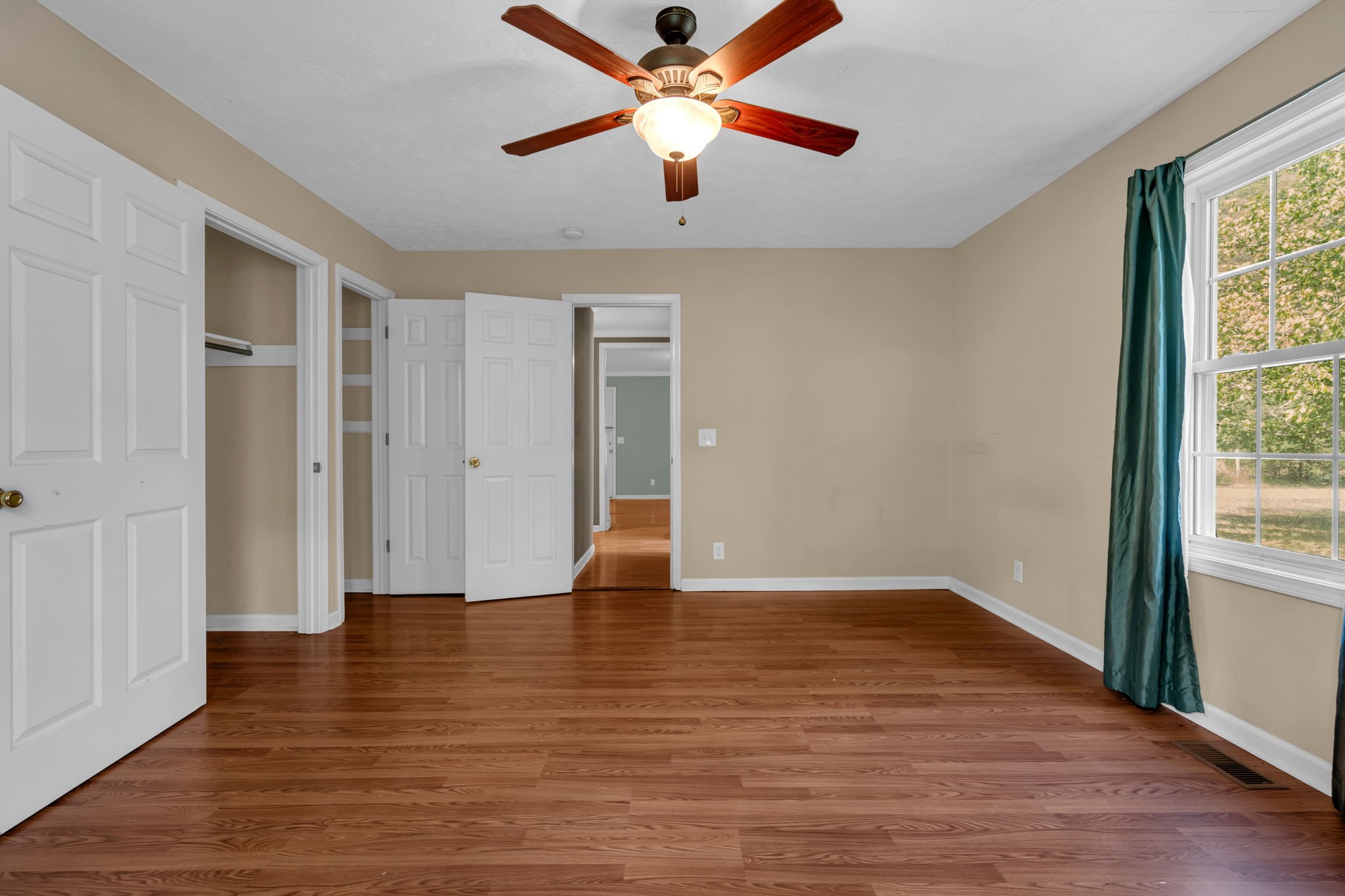 1297 Dry Creek Road Ashland City, TN 37015 - Photo 19 of 27 a view of an empty room with window and wooden floor