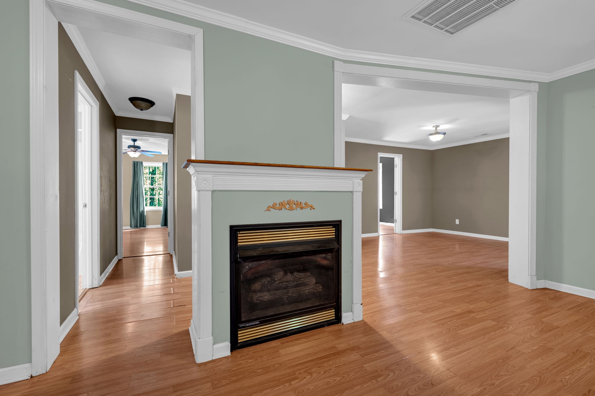 1297 Dry Creek Road Ashland City, TN 37015 - Photo 4 of 27 a view of an empty room with wooden floor fireplace and a window