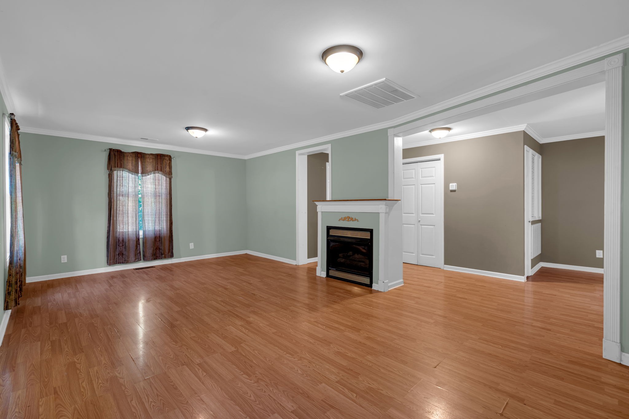 1297 Dry Creek Road Ashland City, TN 37015 - Photo 6 of 27 a view of empty room with wooden floor and fireplace