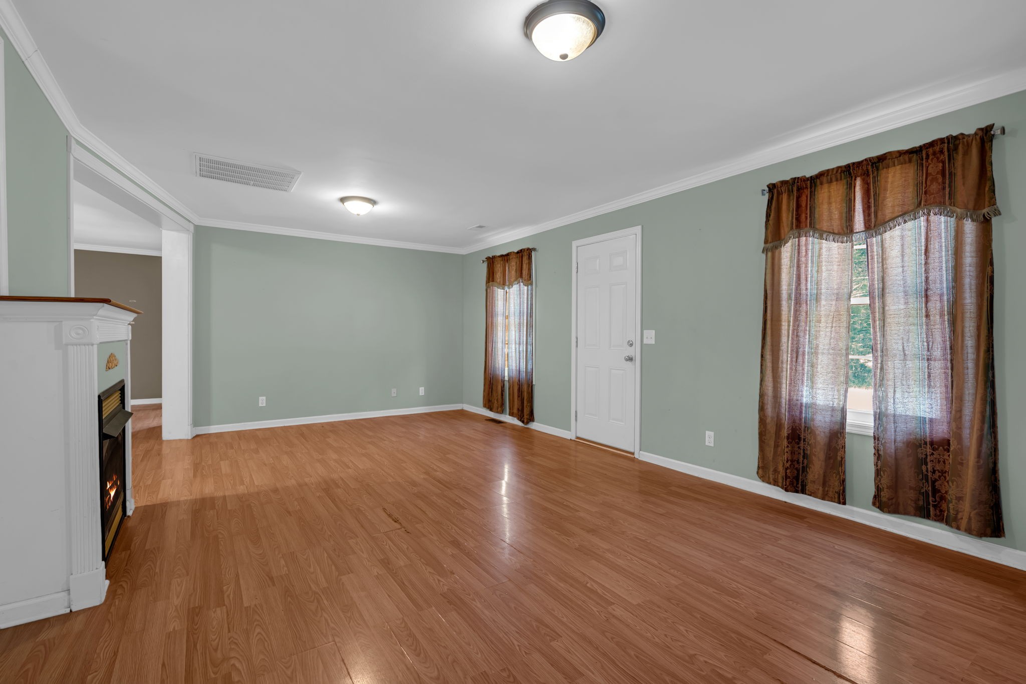 1297 Dry Creek Road Ashland City, TN 37015 - Photo 7 of 27 an empty room with wooden floor and a window