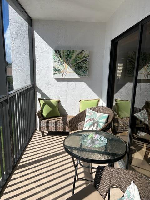 1605 Highway 1, Unit A301 Jupiter, FL 33477 - Photo 13 of 35 a view of a chairs and table in the balcony