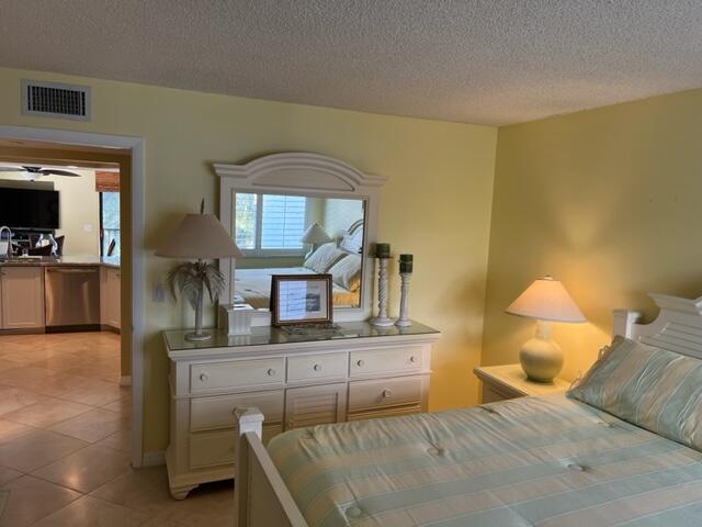 1605 Highway 1, Unit A301 Jupiter, FL 33477 - Photo 20 of 35 a bedroom with a bed a mirror and desk