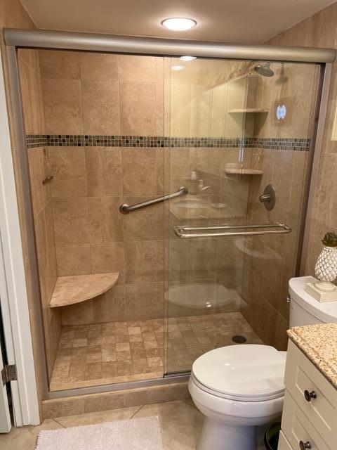 1605 Highway 1, Unit A301 Jupiter, FL 33477 - Photo 24 of 35 a bathroom with a toilet and a shower