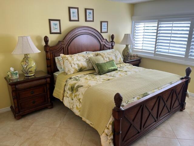 1605 Highway 1, Unit A301 Jupiter, FL 33477 - Photo 26 of 35 a bed sitting in a bedroom next to a window