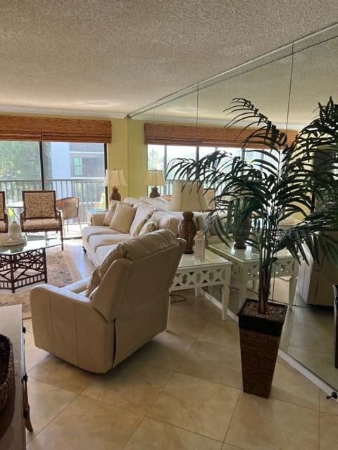 1605 Highway 1, Unit A301 Jupiter, FL 33477 - Photo 5 of 35 a living room with couch and a potted plant