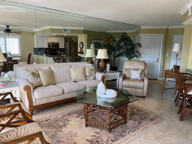 1605 Highway 1, Unit A301 Jupiter, FL 33477 - Photo 8 of 35 a living room with furniture and a dining table with kitchen view