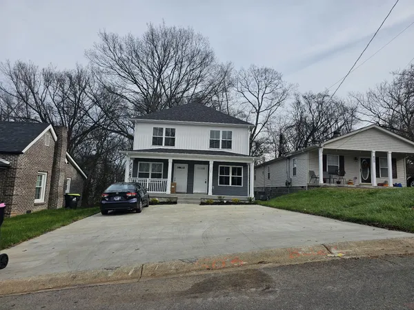 a car parked in front of white house
