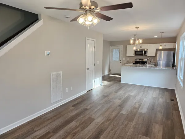 a view of a kitchen with a sink cabinets and wooden floor