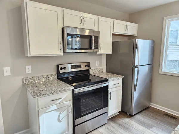 a kitchen with a stove microwave and refrigerator