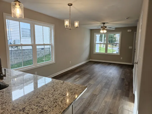 a view of a room with wooden floor and a window