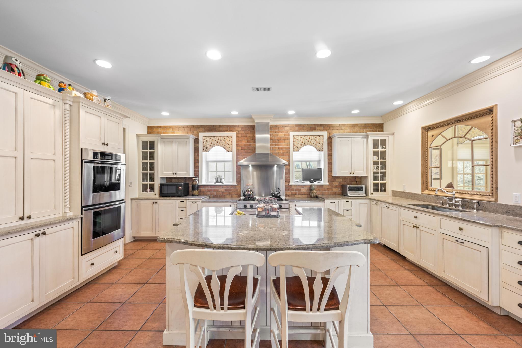 825 Hagys Ford Road Penn Valley, PA 19072 - Photo 12 of 45 a kitchen with stainless steel appliances granite countertop a stove top oven a sink a refrigerator and white cabinets