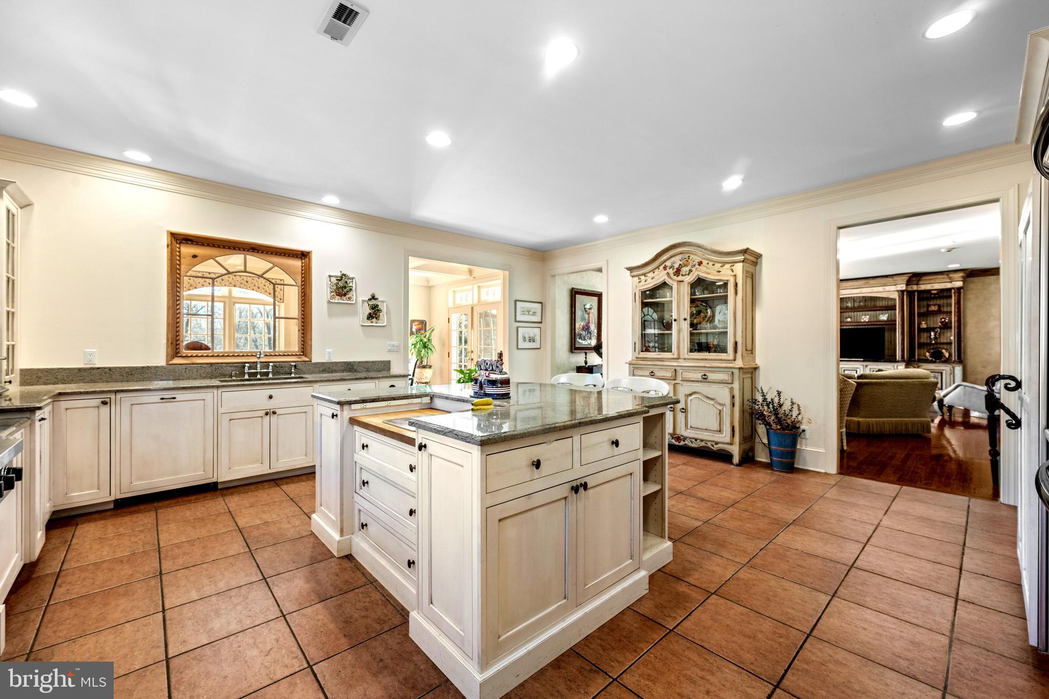 825 Hagys Ford Road Penn Valley, PA 19072 - Photo 16 of 45 a large white kitchen with a stove a sink a window and dining table