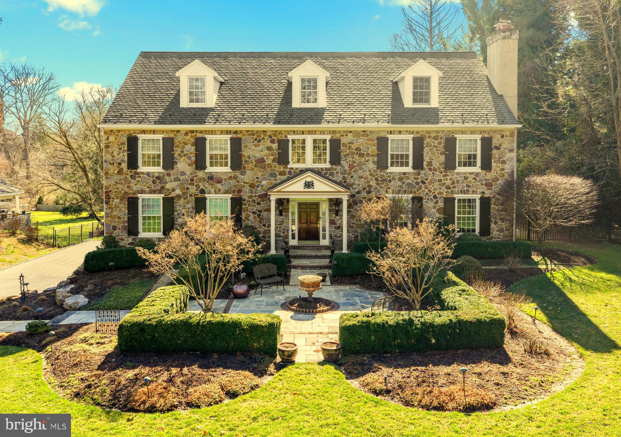 825 Hagys Ford Road Penn Valley, PA 19072 - Photo 3 of 45 a front view of a house with a yard and fountain