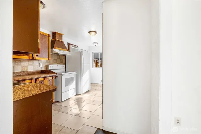 a kitchen with a refrigerator and a stove