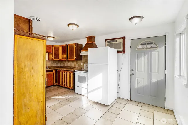 a kitchen with refrigerator and cabinets
