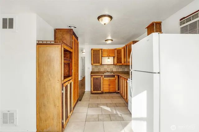 a kitchen with stainless steel appliances a refrigerator and a stove