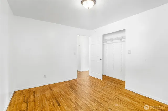 a view of a room with wooden floor and bathroom
