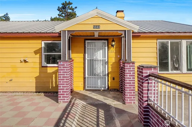 an entrance to house with yard