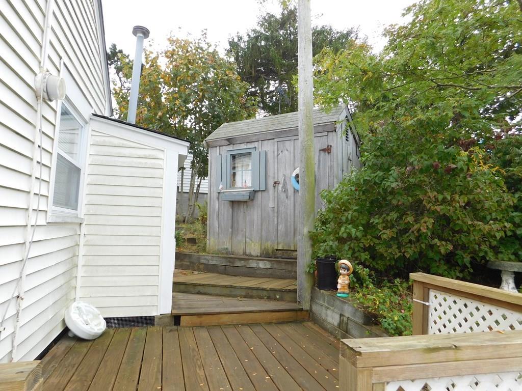 218 Old Wharf Road, Unit 218 Dennis, MA 02639 - Photo 12 of 32 a view of a deck with chairs and wooden floor