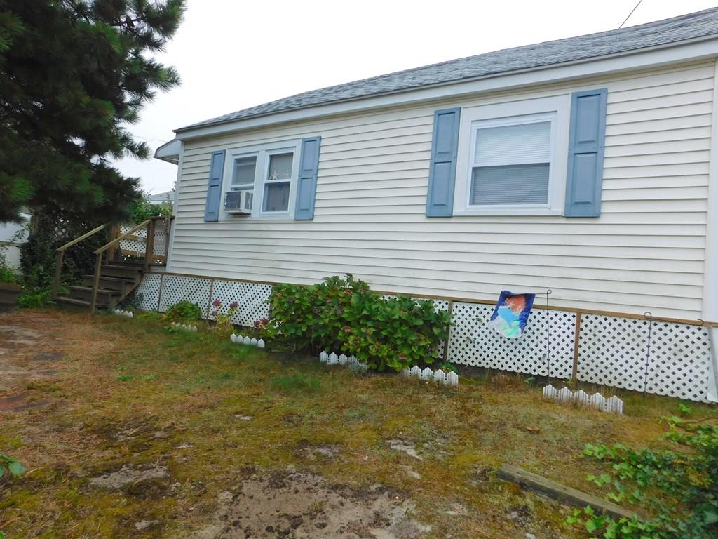 218 Old Wharf Road, Unit 218 Dennis, MA 02639 - Photo 13 of 32 a front view of a house with garden