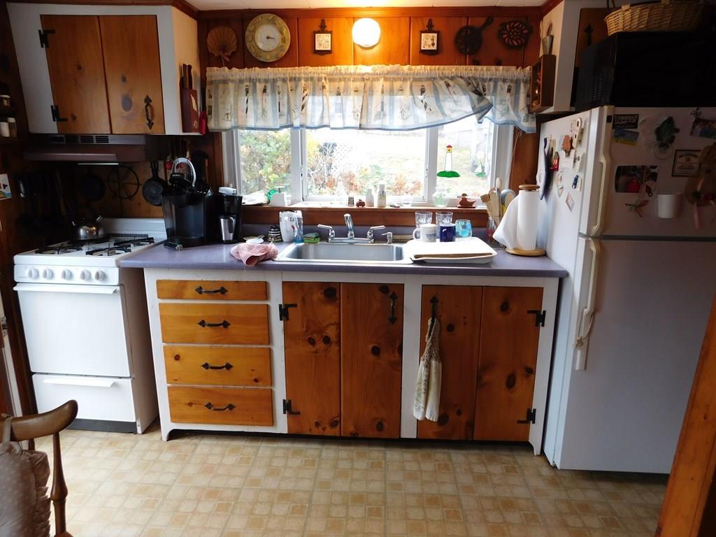 218 Old Wharf Road, Unit 218 Dennis, MA 02639 - Photo 16 of 32 a kitchen with a stove and a refrigerator
