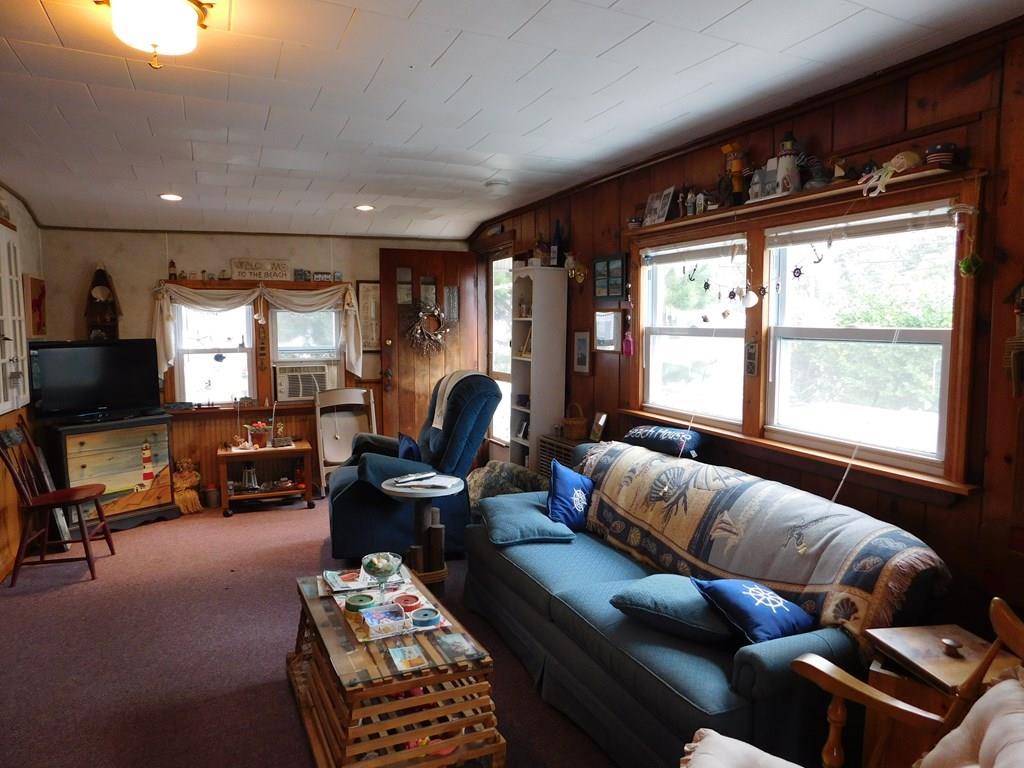 218 Old Wharf Road, Unit 218 Dennis, MA 02639 - Photo 19 of 32 a living room with furniture and a flat screen tv