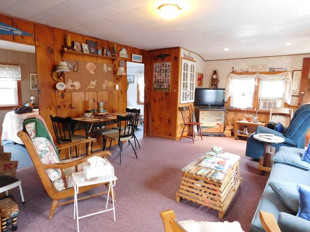 218 Old Wharf Road, Unit 218 Dennis, MA 02639 - Photo 20 of 32 a living room with furniture and a large window