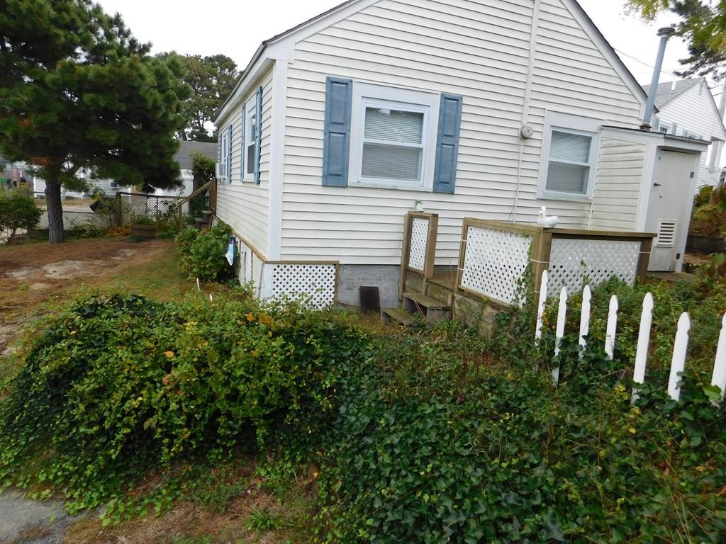 218 Old Wharf Road, Unit 218 Dennis, MA 02639 - Photo 2 of 32 a view of a house with backyard and sitting area