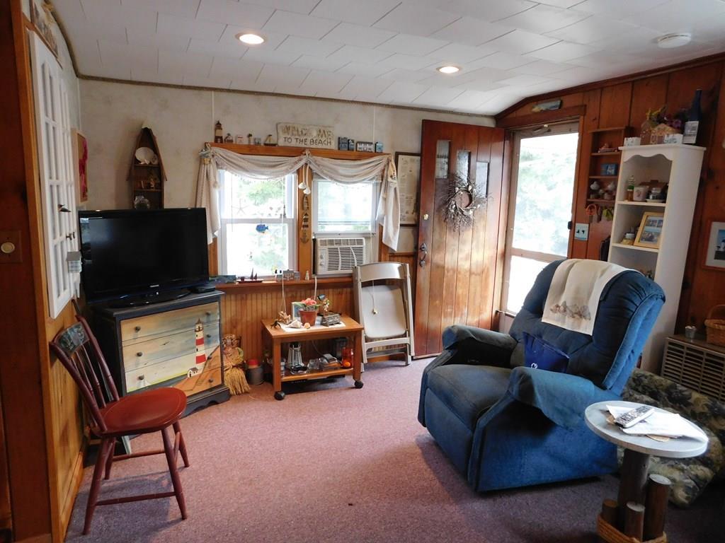 218 Old Wharf Road, Unit 218 Dennis, MA 02639 - Photo 23 of 32 a living room with furniture a flat screen tv and a window