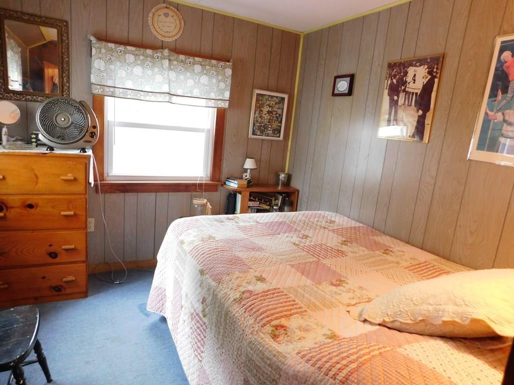 218 Old Wharf Road, Unit 218 Dennis, MA 02639 - Photo 25 of 32 a bedroom with a bed and a dresser
