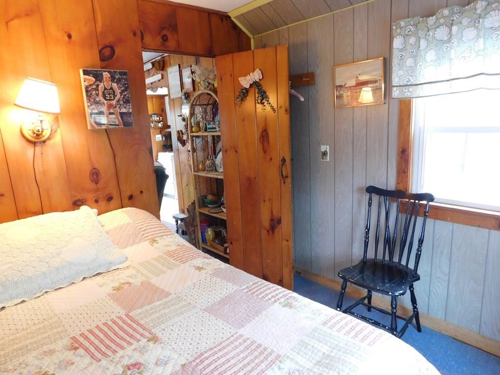 218 Old Wharf Road, Unit 218 Dennis, MA 02639 - Photo 26 of 32 a bedroom with a bed and a chair in it