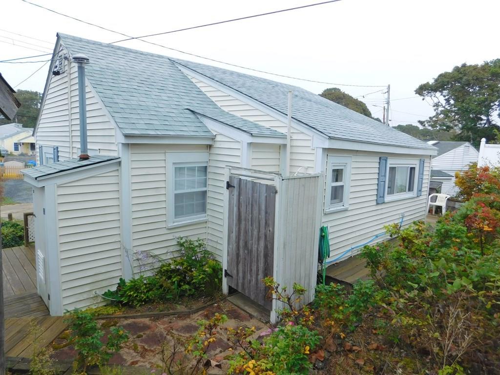218 Old Wharf Road, Unit 218 Dennis, MA 02639 - Photo 7 of 32 a view of a house with backyard and plants