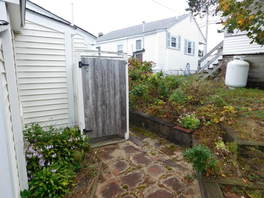 218 Old Wharf Road, Unit 218 Dennis, MA 02639 - Photo 10 of 32 a view of a house with backyard and sitting area