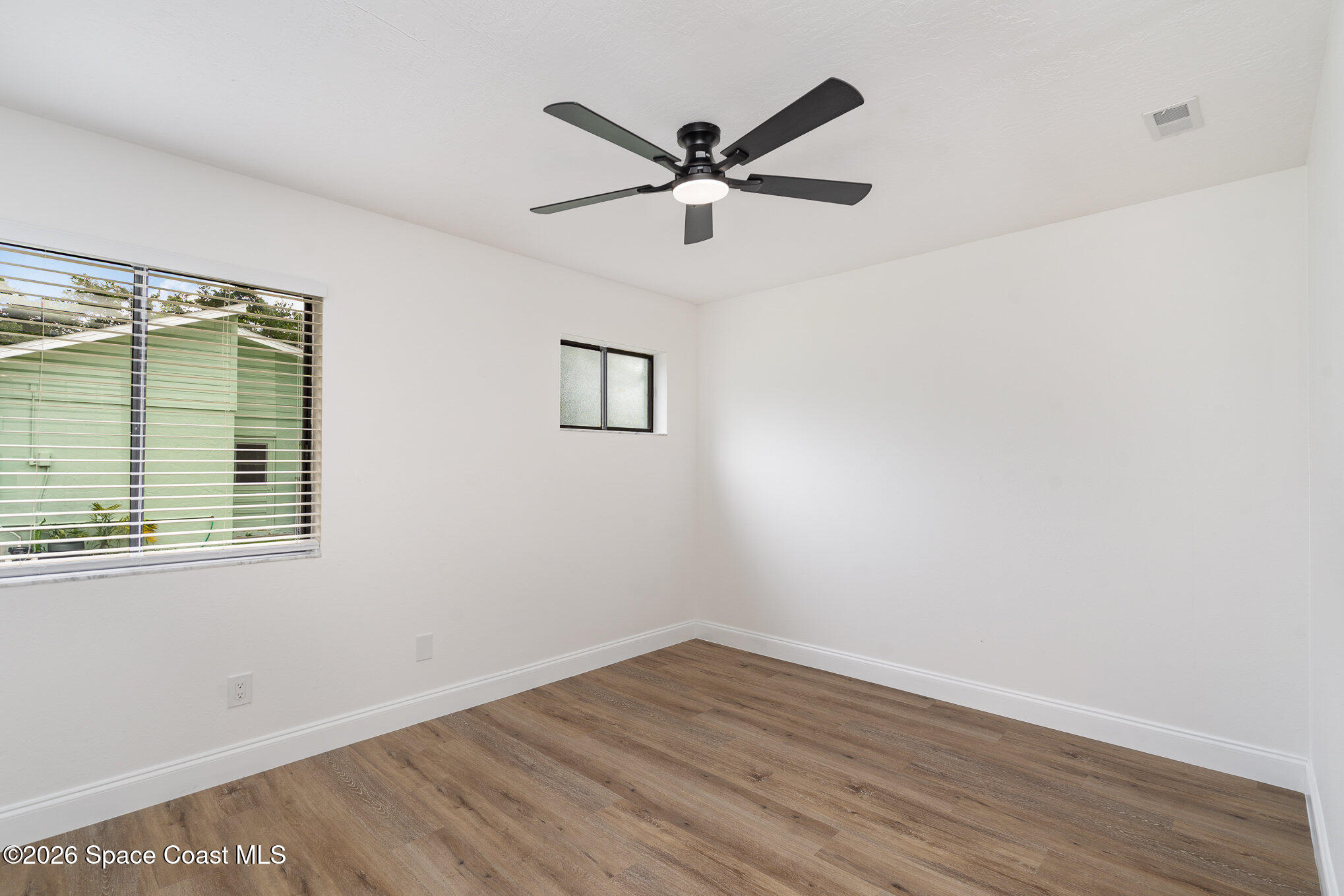 362 Nikomas Way Melbourne Beach, FL 32951 - Photo 17 of 32 a view of a room with wooden floor and a ceiling fan