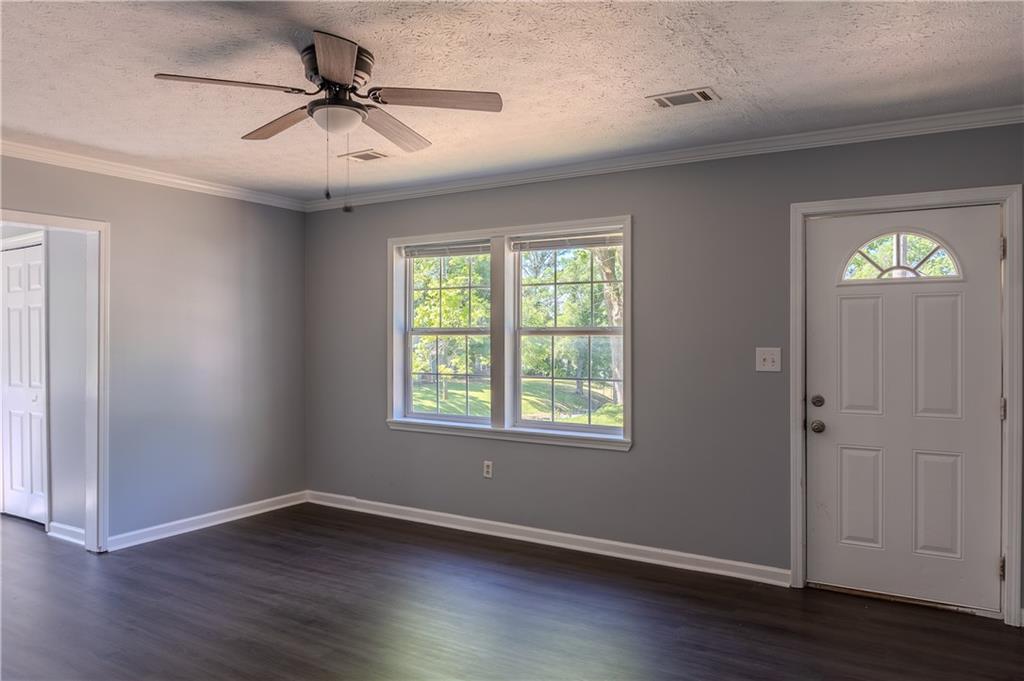 53 Washington Drive Forsyth, GA 31029 - Photo 3 of 19 a view of an empty room with wooden floor and a window
