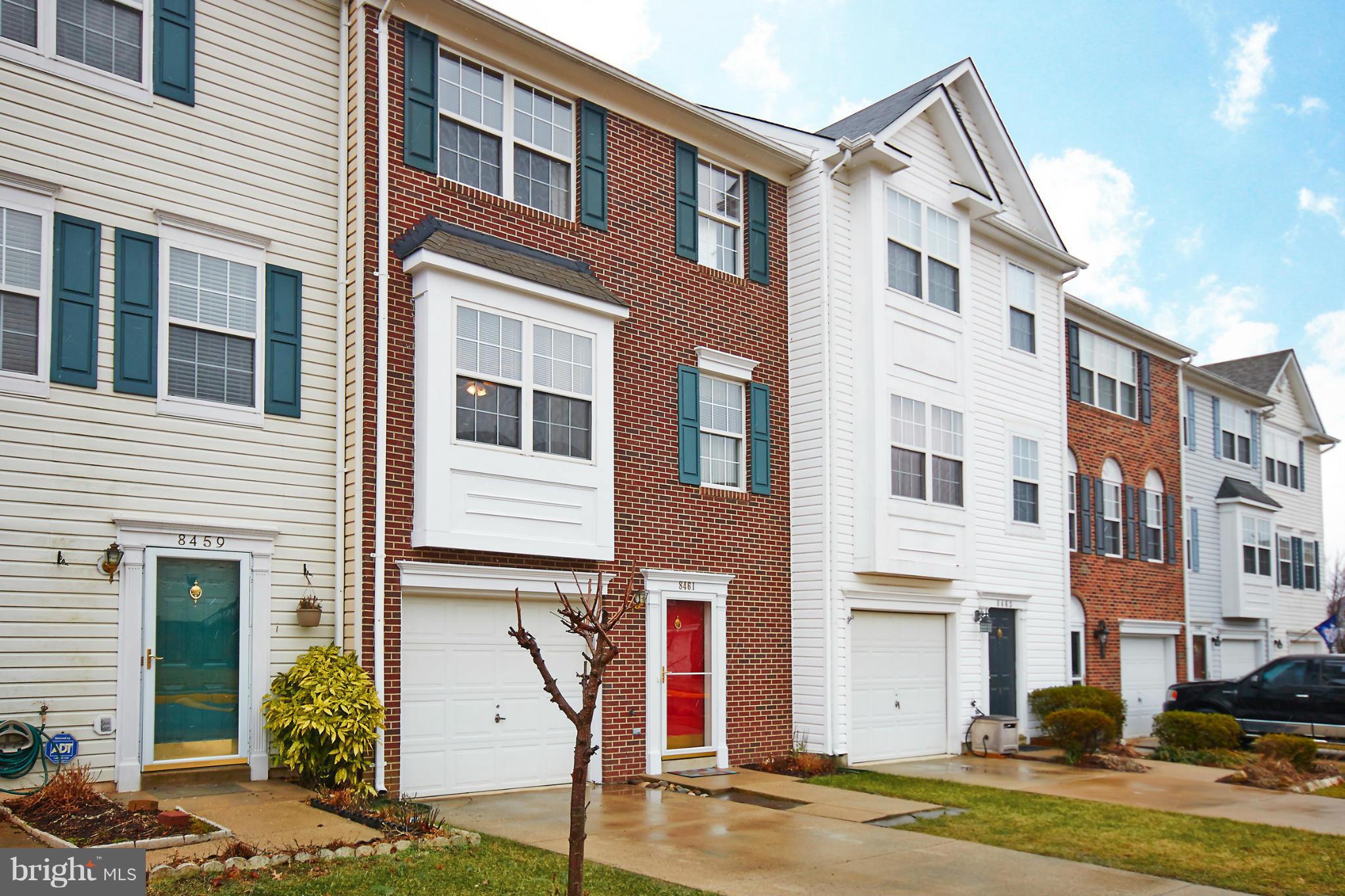 a front view of a residential apartment building with a yard
