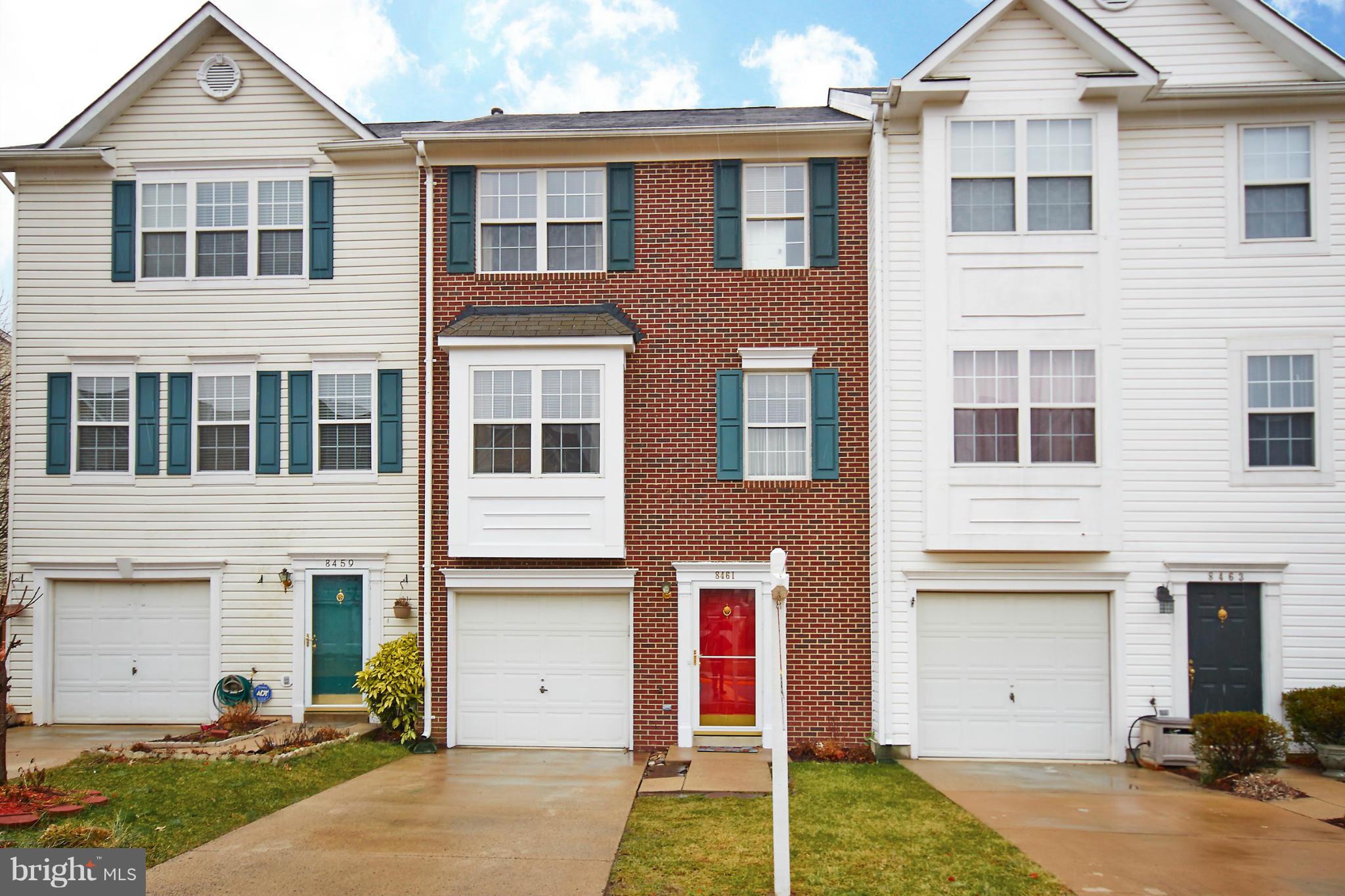 8461 Tackhouse Loop Gainesville, VA 20155 - Photo 2 of 29 a front view of a house with a yard and garage