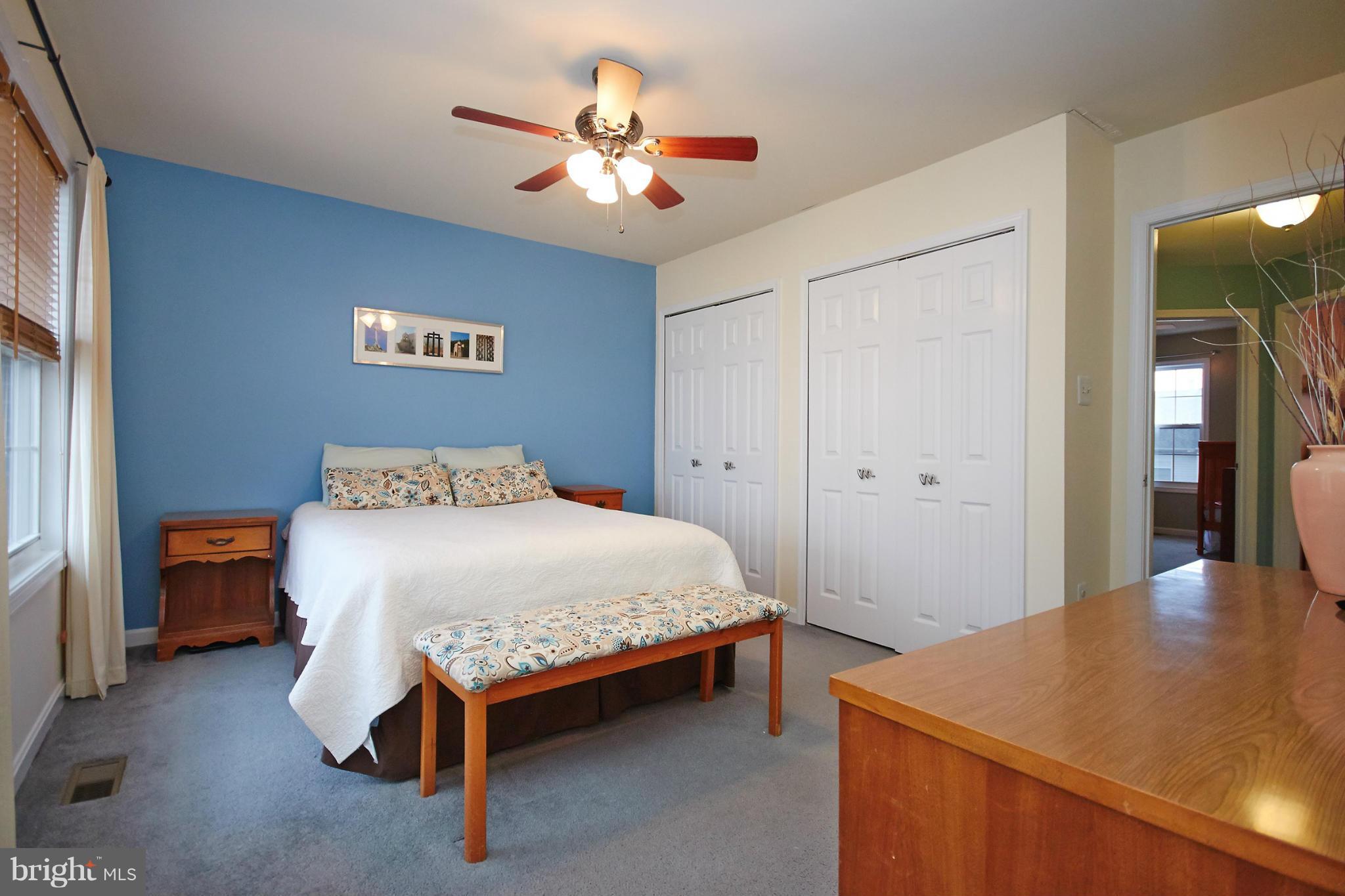 8461 Tackhouse Loop Gainesville, VA 20155 - Photo 14 of 29 a bedroom with a bed and a chandelier