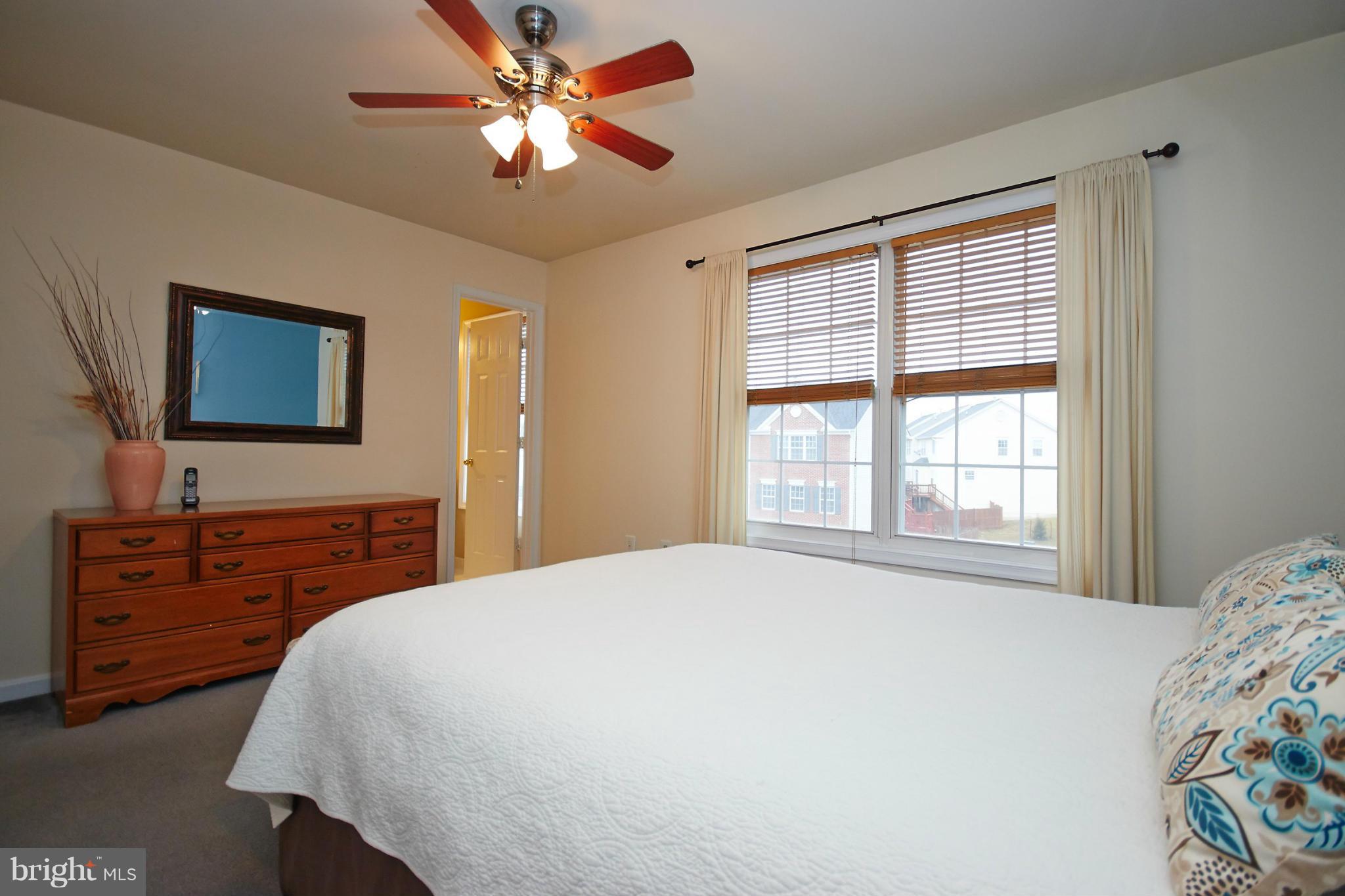 8461 Tackhouse Loop Gainesville, VA 20155 - Photo 15 of 29 a bedroom with a large bed and a dresser