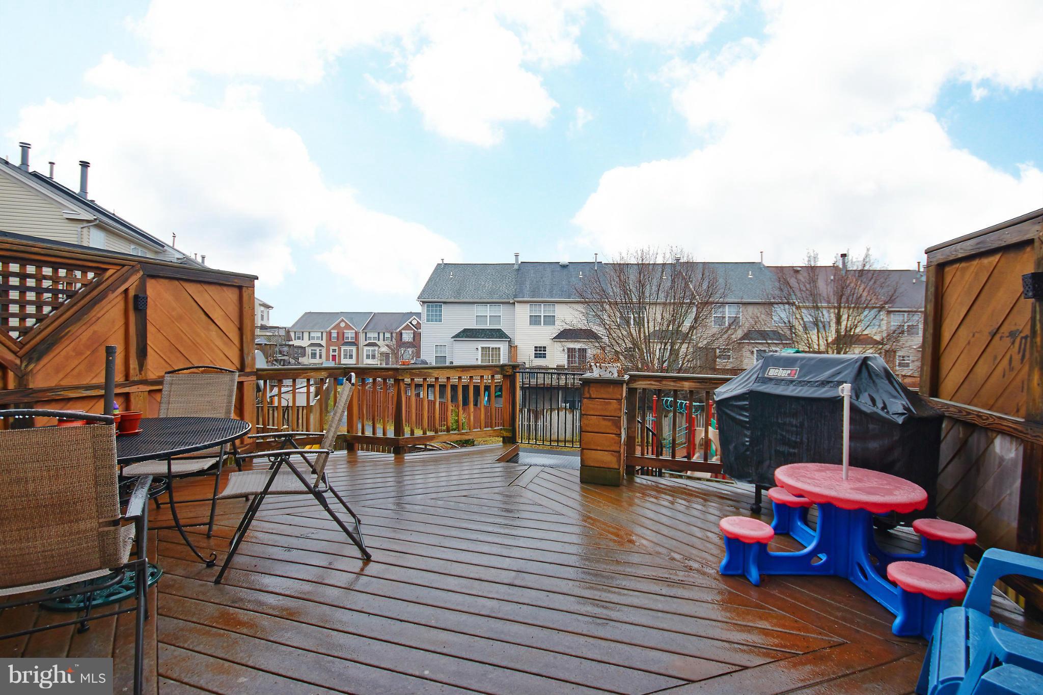 8461 Tackhouse Loop Gainesville, VA 20155 - Photo 23 of 29 a balcony with wooden floor table and chairs