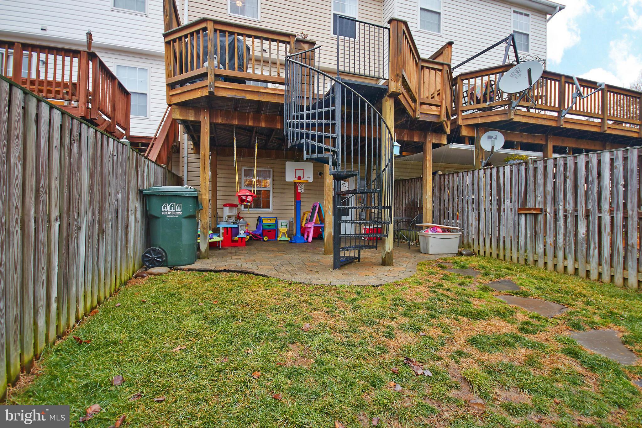 8461 Tackhouse Loop Gainesville, VA 20155 - Photo 26 of 29 a view of a brick house with many windows