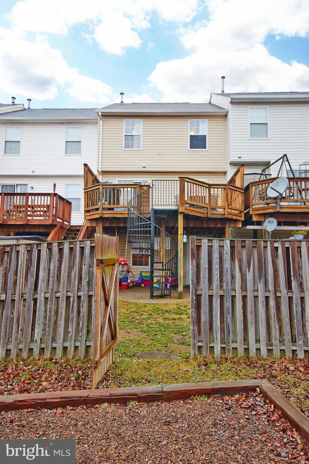 8461 Tackhouse Loop Gainesville, VA 20155 - Photo 27 of 29 a view of a house with wooden fence