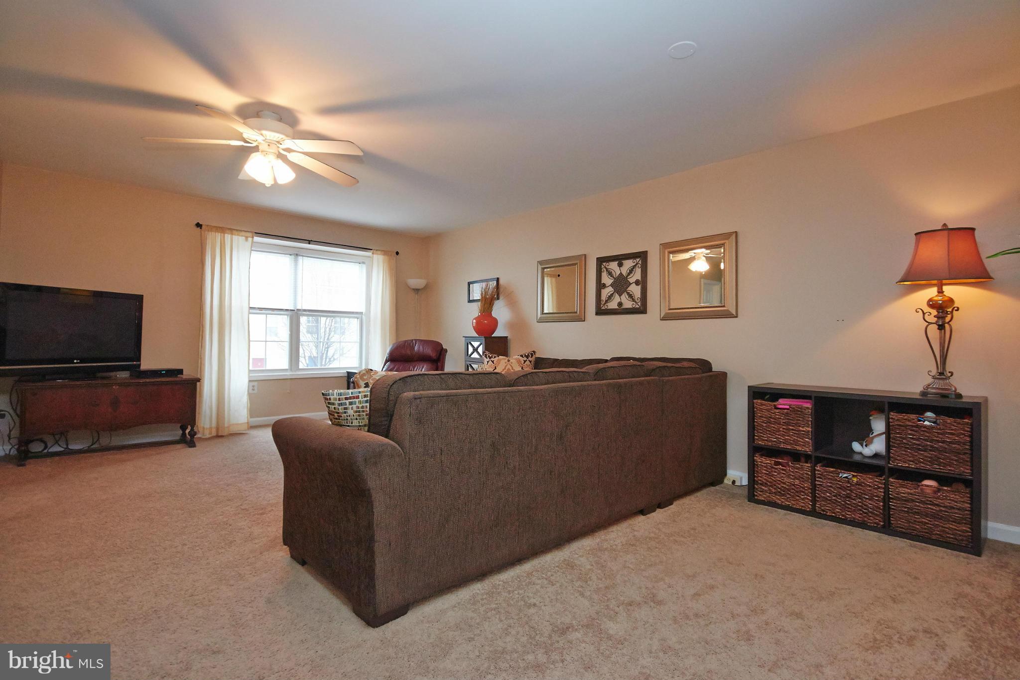 8461 Tackhouse Loop Gainesville, VA 20155 - Photo 7 of 29 a living room with furniture and a flat screen tv