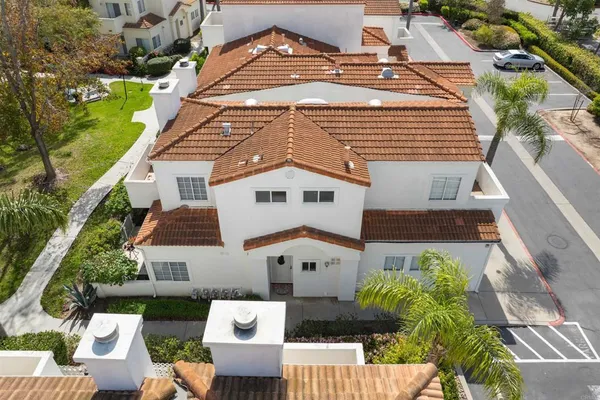 an aerial view of a house with a yard