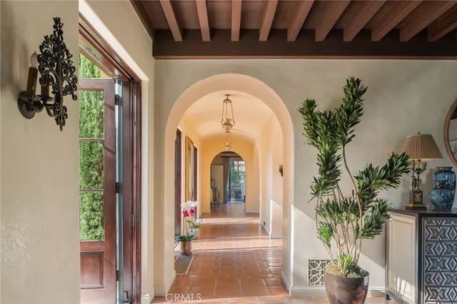a vase of flowers sitting on a floor in front of a building