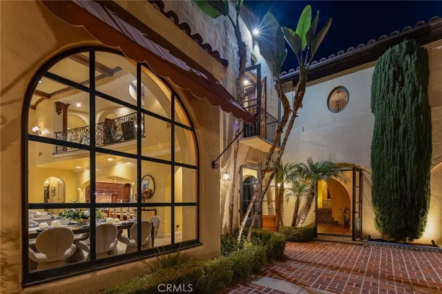 a large kitchen with stainless steel appliances granite countertop a sink dishwasher a stove and a dining table with wooden floor