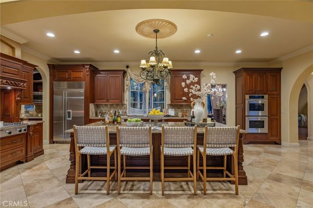 a bedroom with a large bed and a fireplace