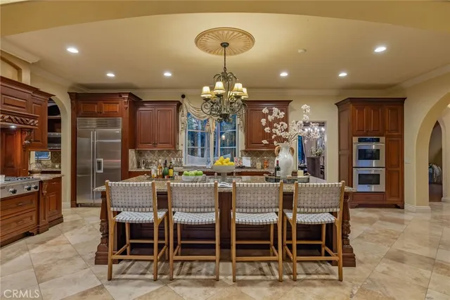 a bedroom with a large bed and a fireplace