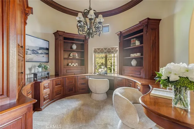 a view of a swimming pool with lawn chairs and a fire pit